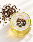 Timebai_Coconut_Jasmine_Tea_brewing_in_a_glass_cup_with_a_hanging_filter_bag