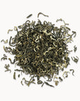 Timebai early spring bi luo chun green tea loose leaves piled on a white background.