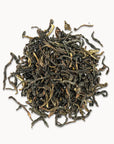 Timebai gardenia dancong oolong tea loose leaves piled on a white background.