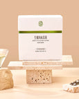 Timebai Coconut Jasmine Green Tea product set showing the packaging, green tea leaves, coconut flakes and brewed tea.