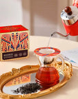 Hand-pouring hot water over Timebai Ceylan Island Estate Black Tea disc for a brisk morning cup.