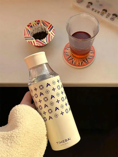 Hand holding a travel tumbler with TimeBai drip disc tea