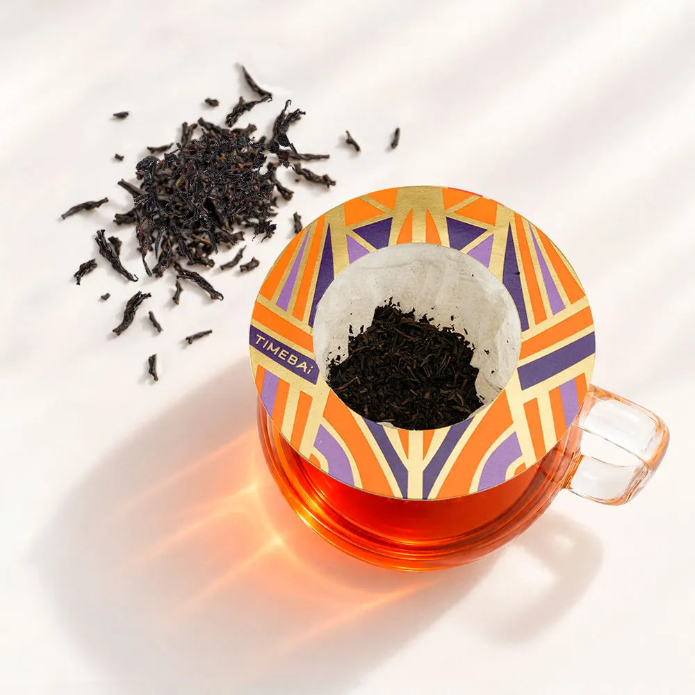 Timebai Da Hong Pao Wuyi Rock Oolong Tea Brewing in a Glass Cup with a Hanging Filter Bag