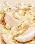 Timebai_Coconut_Jasmine_Tea_coconut_slices_and_jasmine_flowers_in_iced_golden_tea