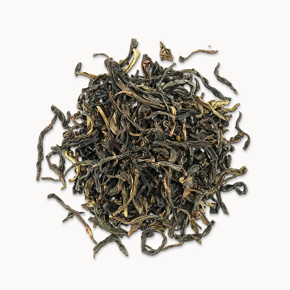 Timebai gardenia dancong oolong tea loose leaves piled on a white background.