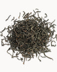 Timebai golden peony black tea loose leaves piled on a white background.