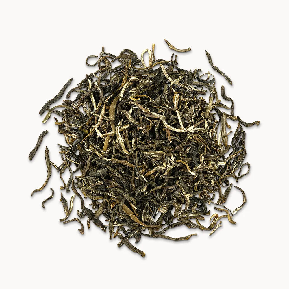 Timebai jasmine mao jian green tea loose leaves piled on a white background.