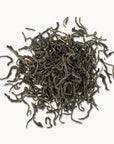 Timebai_yunnan_beauty_black_tea_loose_leaves_piled_on_a_white_background.