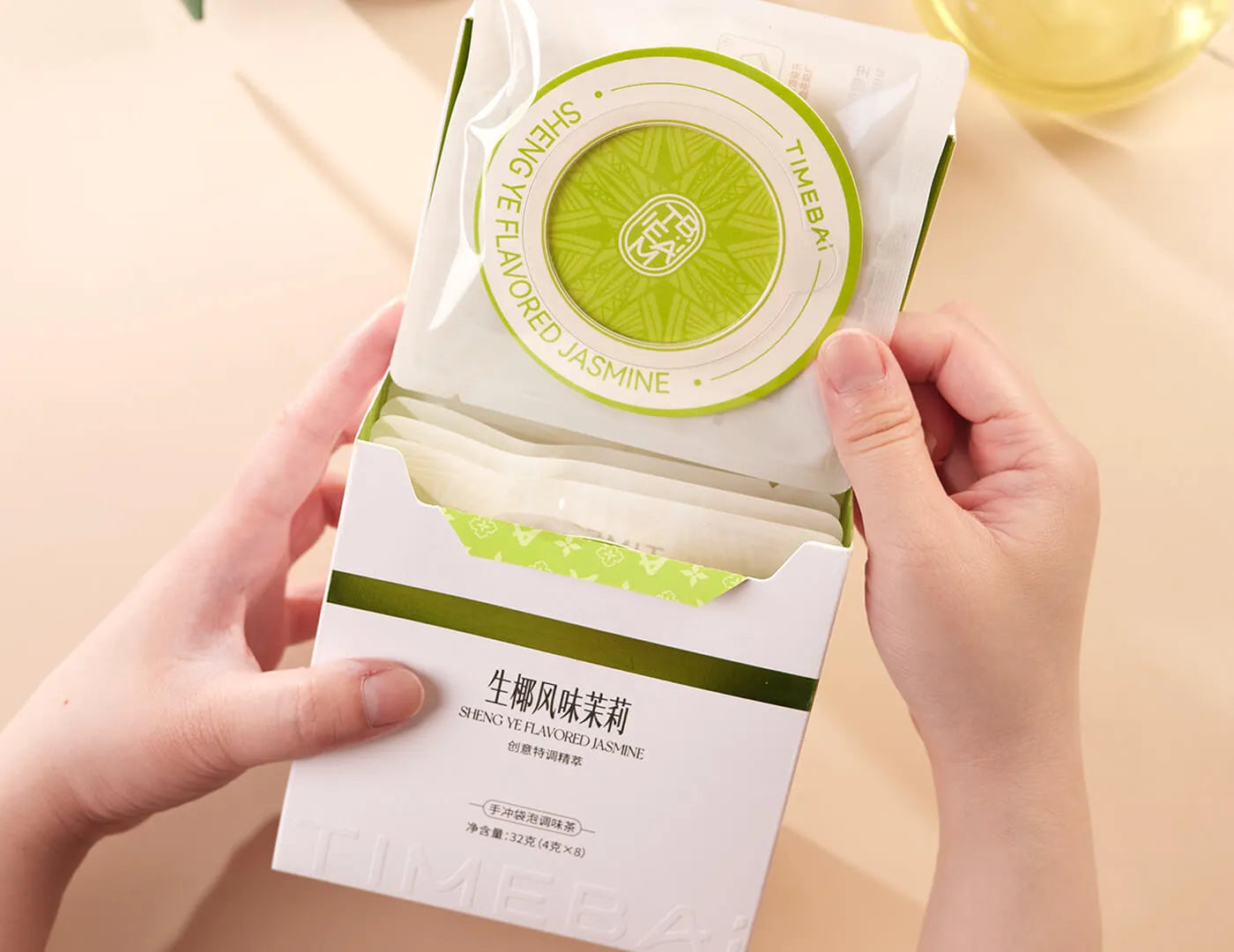 Retail box of Timebai coconut flavored jasmine green tea containing 8 individual UFO tea bag.