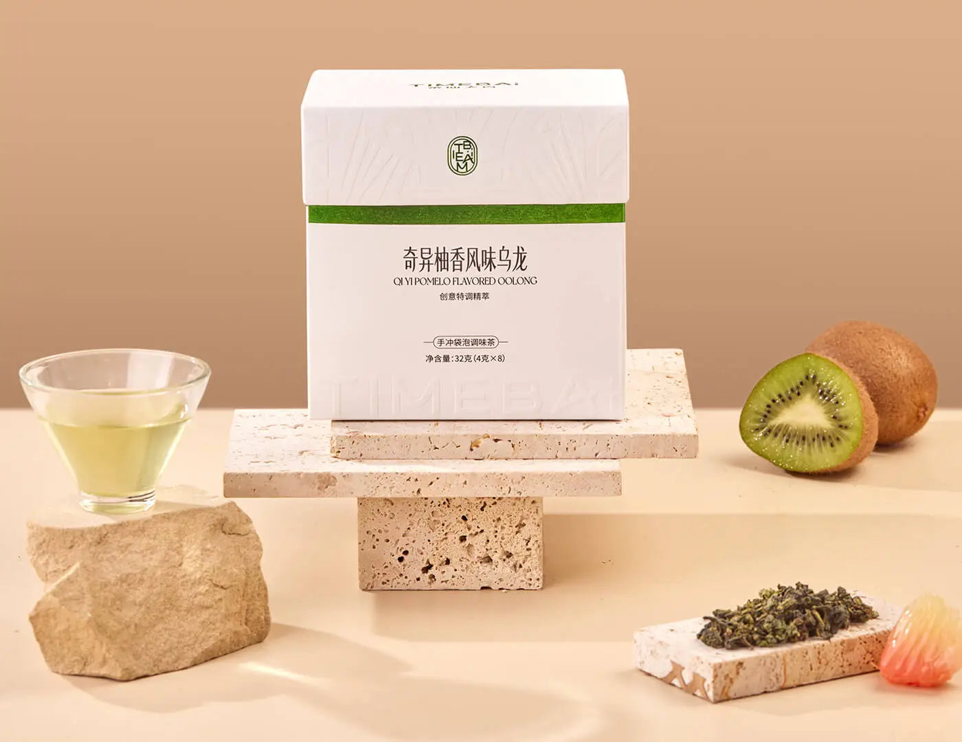 Timebai Kiwi Pomelo Oolong Tea product set showing the packaging, oolong leaves, kiwi fruit, pomelo fruit and brewed tea.