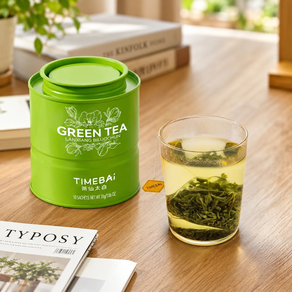 Timebai Orchid Bi Luo Chun Green Tea Tin Beside a Glass of Brewed Green Tea