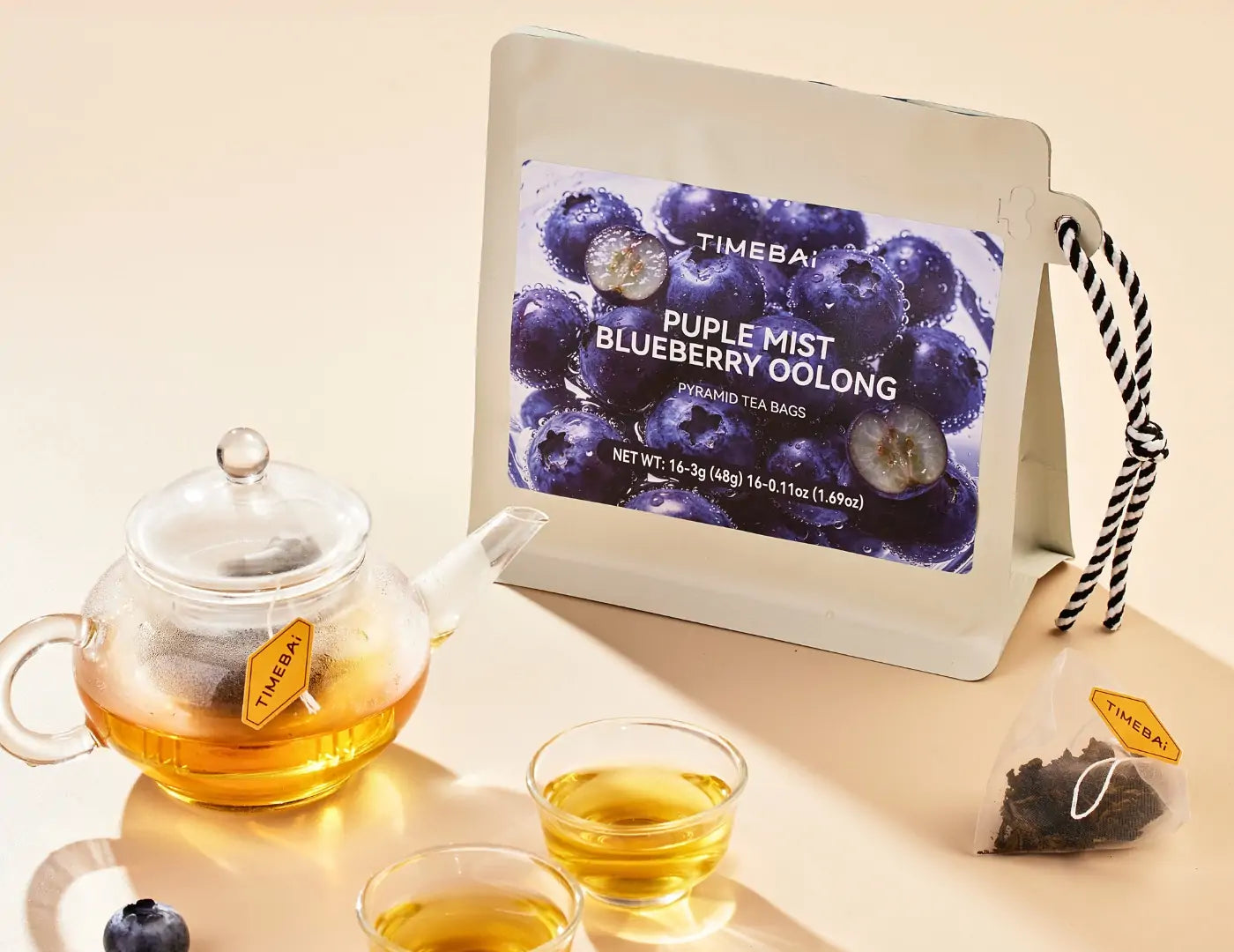 TimeBai Blueberry Oolong Tea pouch with pyramid tea bag and brewed oolong tea
