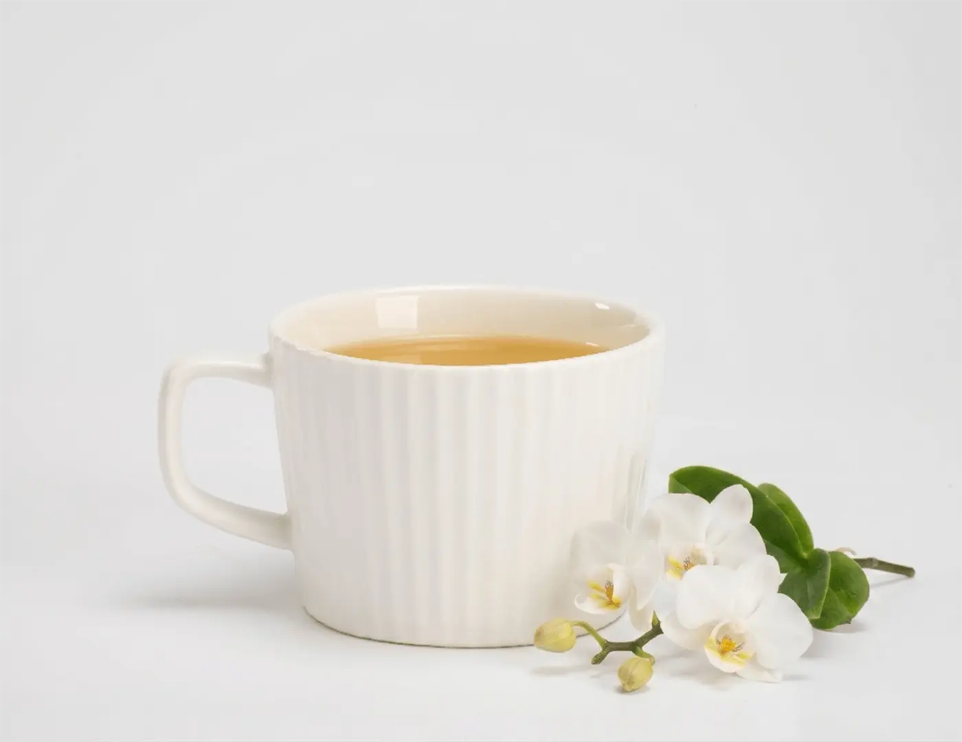Enjoy a cup of Bi Luo Chun green tea infused with orchid essence.