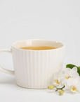 Enjoy a cup of Bi Luo Chun green tea infused with orchid essence.