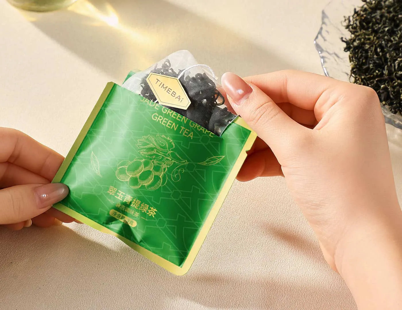 Premium 100% plastic-free pyramid tea bags with loose leaf green tea and infused fruit.