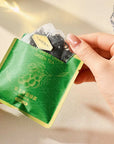 Premium 100% plastic-free pyramid tea bags with loose leaf green tea and infused fruit.