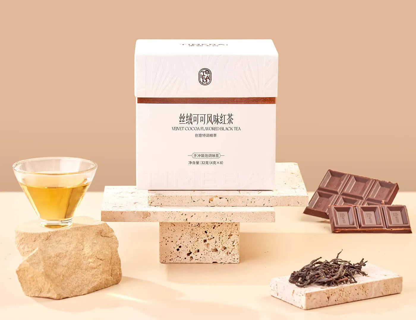 Timebai Chocolate Black Tea product set showing the packaging, oolong leaves, chocolate and brewed tea.