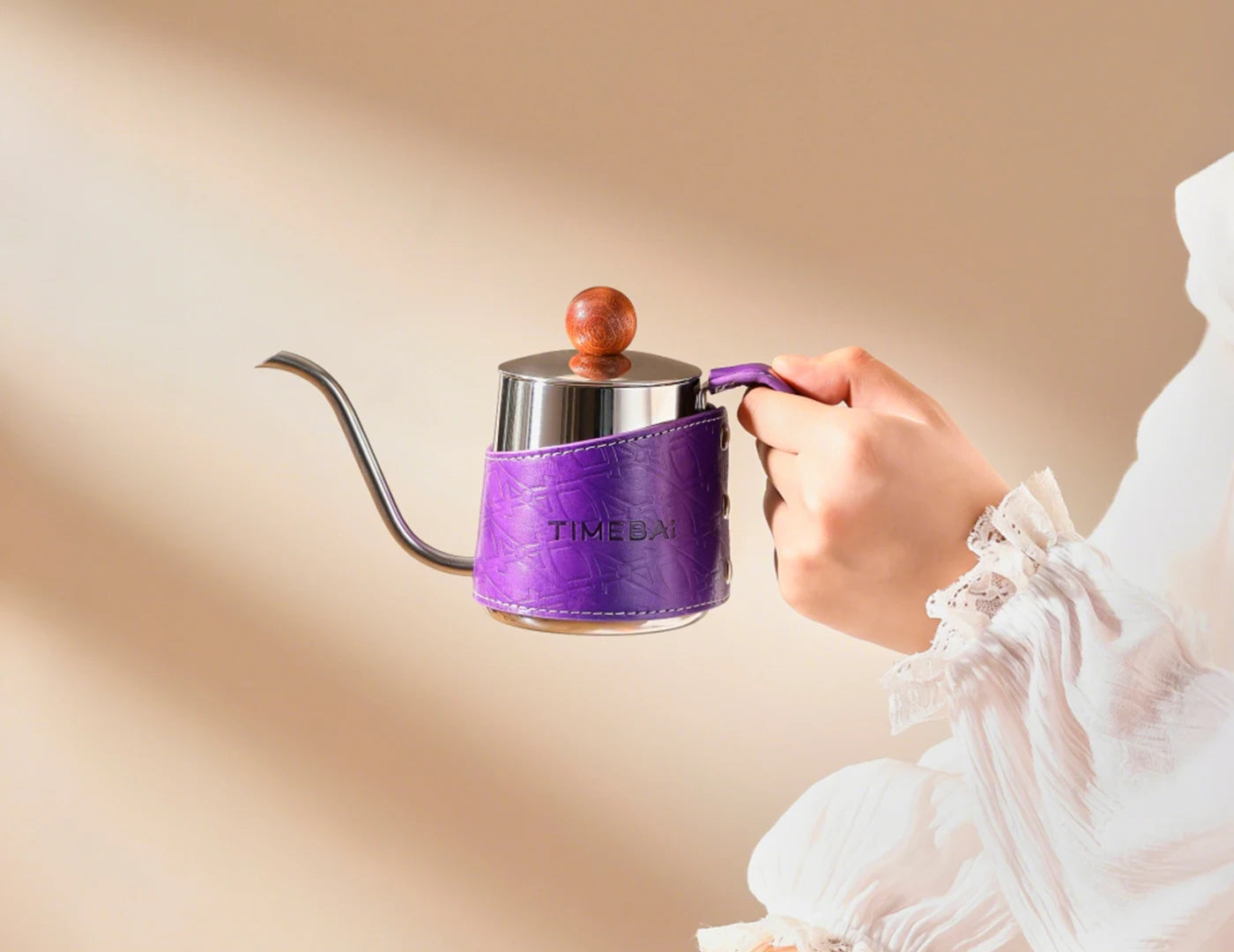 Handheld TimeBai kettle with comfortable leather grip.
